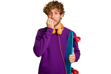 Young skater caucasian man isolated on white background biting fingernails, nervous and very anxious.