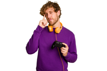 Young caucasian gamer man holding a game controller isolated on white background pointing temple with finger, thinking, focused on a task.