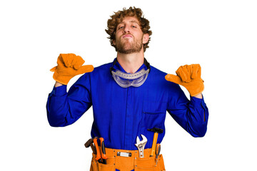 Young caucasian electrician man isolated on white background feels proud and self confident,...