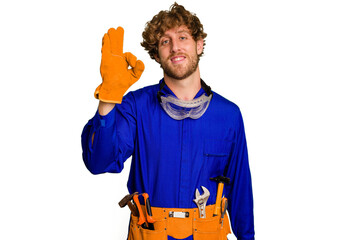 Young caucasian electrician man isolated on white background cheerful and confident showing ok...