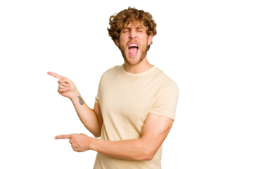 Young caucasian man isolated on green chroma background pointing with forefingers to a copy space, expressing excitement and desire.