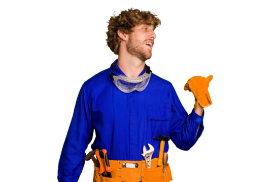 Young caucasian electrician man isolated on white background points with thumb finger away, laughing and carefree.