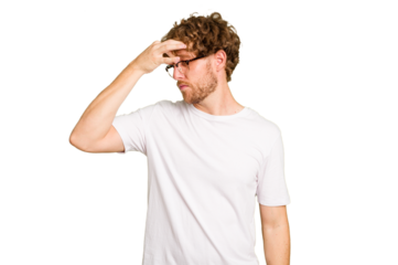 Young caucasian man isolated on green chroma background having a head ache, touching front of the face.