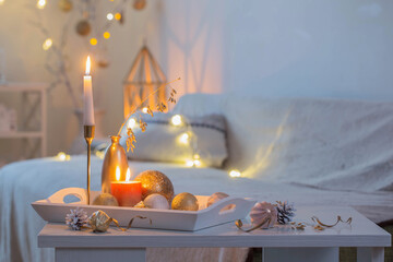 christmas home decorations with candles in white interior
