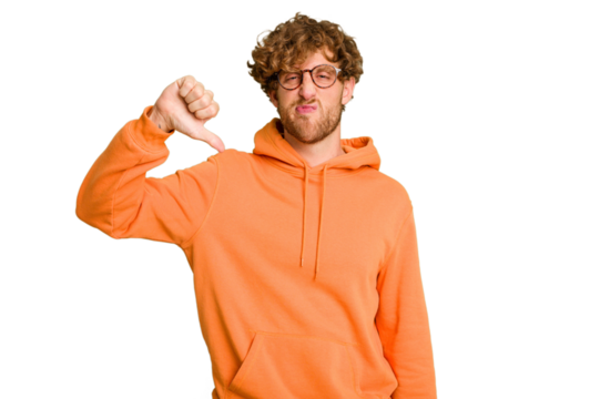 Young caucasian man isolated on green chroma background showing thumb down, disappointment concept.