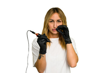 Tattoo artist caucasian woman isolated on green chroma background with fingers on lips keeping a secret.