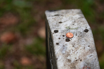 Penny left on a military headstone