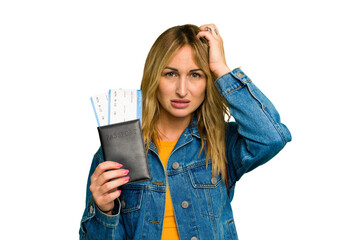 Young caucasian woman holding a passport isolated on green chroma background being shocked, she has...