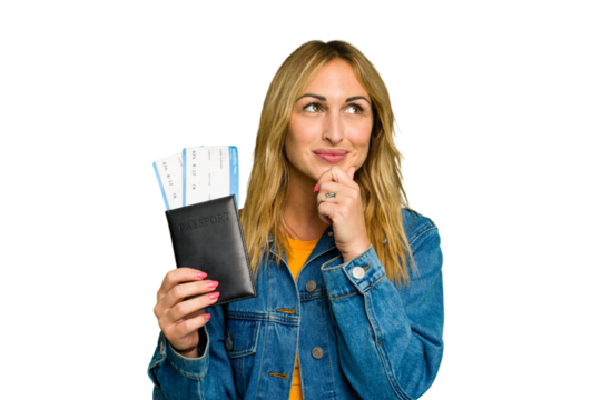 Young caucasian woman holding a passport isolated on green chroma background looking sideways with doubtful and skeptical expression.