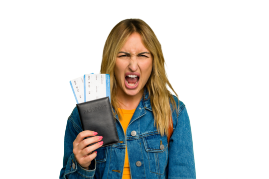 Young caucasian woman holding a passport isolated on green chroma background screaming very angry and aggressive.
