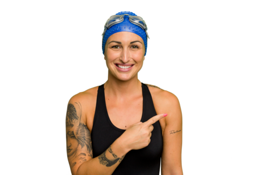 Young caucasian swimmer woman isolated on green chroma background smiling and pointing aside, showing something at blank space.