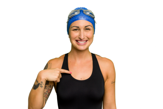 Young caucasian swimmer woman isolated on green chroma background person pointing by hand to a shirt copy space, proud and confident