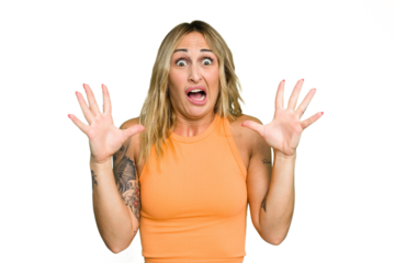 Young caucasian woman isolated on green chroma background screaming to the sky, looking up, frustrated.
