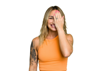 Young caucasian woman isolated on green chroma background having fun covering half of face with palm.