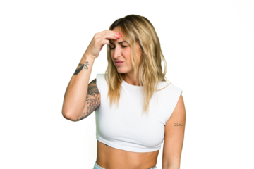 Young caucasian woman isolated on green chroma background having a head ache, touching front of the face.