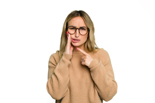 Young caucasian woman isolated on green chroma background having a strong teeth pain, molar ache.