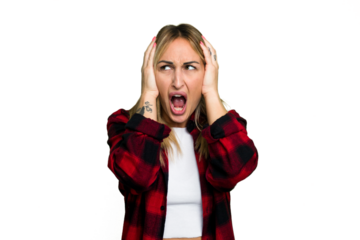 Young caucasian woman isolated on green chroma background covering ears with hands trying not to hear too loud sound.