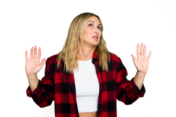 Young caucasian woman isolated on green chroma background being shocked due to an imminent danger