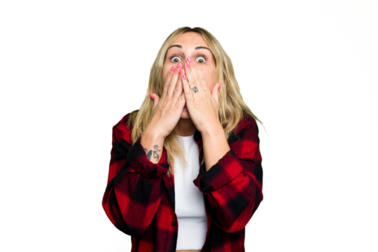 Young caucasian woman isolated on green chroma background shocked, covering mouth with hands, anxious to discover something new.