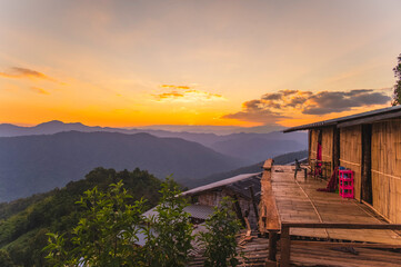 Old bamboo hut with sunset mountains