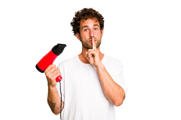 Young caucasian man holding an hairdryer isolated keeping a secret or asking for silence.