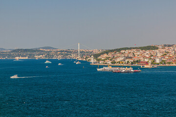 Fototapeta na wymiar Boats and First Bosporus Bridge (15 July Martyrs Bridge) in Istanbul, Turkey