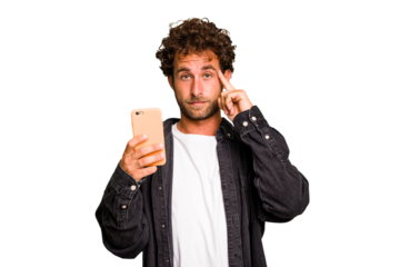 Young caucasian man using mobile phone isolated pointing temple with finger, thinking, focused on a task.