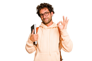 Young caucasian student man isolated cheerful and confident showing ok gesture. - obrazy, fototapety, plakaty