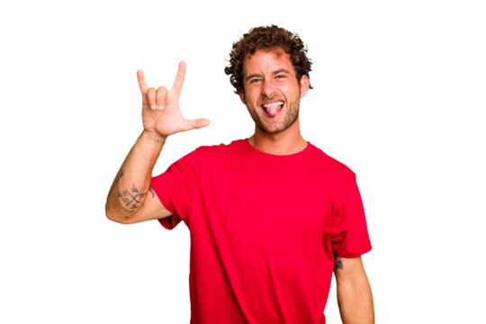 Young caucasian curly hair man isolated Young caucasian man with curly hair isolated showing a horns gesture as a revolution concept.