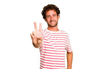 Naklejka premium Young caucasian curly hair man isolated Young caucasian man with curly hair isolated showing victory sign and smiling broadly.