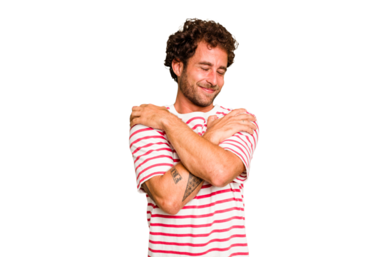 Young caucasian curly hair man isolated Young caucasian man with curly hair isolated hugs, smiling carefree and happy.