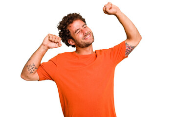 Young caucasian curly hair man isolated Young caucasian man with curly hair isolated celebrating a special day, jumps and raise arms with energy.