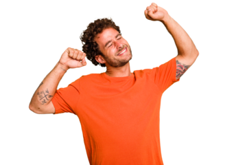 Young caucasian curly hair man isolated Young caucasian man with curly hair isolated celebrating a special day, jumps and raise arms with energy.