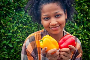Happy teenager holding vegetable at fall day in organic farm. Harvesting on the farm. Vintage tone
