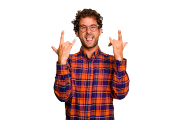 Young caucasian curly hair man isolated Young caucasian man with curly hair isolated showing a horns gesture as a revolution concept.