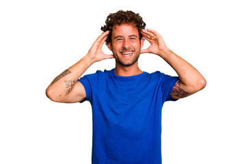 Fototapeta premium Young caucasian curly hair man isolated Young caucasian man with curly hair isolated receiving a pleasant surprise, excited and raising hands.