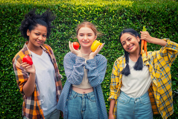 Happy teenager holding vegetable at fall day in organic farm. Harvesting on the farm. Vintage tone