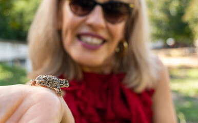 Frog on the arm of a smiling woman