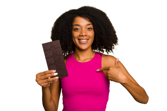 Young African American woman holding a chocolate bar isolated person pointing by hand to a shirt copy space, proud and confident