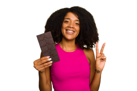 Young African American woman holding a chocolate bar isolated showing number two with fingers.