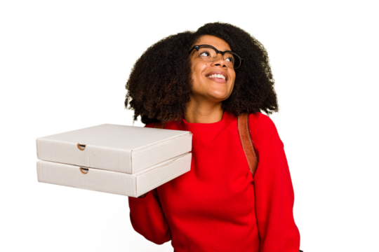 Young student african american woman holding pizzas on isolated dreaming of achieving goals and purposes