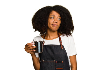 Young African American woman barista isolated confused, feels doubtful and unsure.