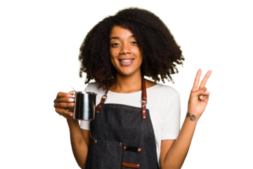 Young African American woman barista isolated joyful and carefree showing a peace symbol with fingers.