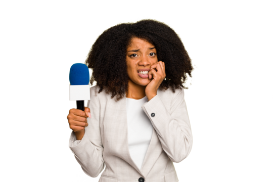 Young TV presenter African American woman with a microphone isolated biting fingernails, nervous and very anxious.