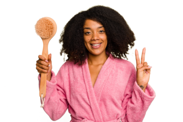 Young African American woman holding a shower brush isolated showing number two with fingers.