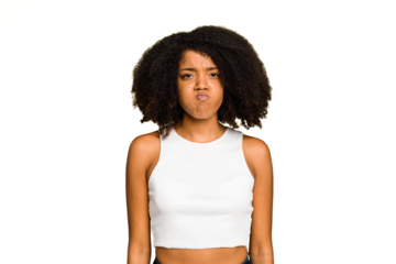 Young African American woman isolated blows cheeks, has tired expression. Facial expression concept.