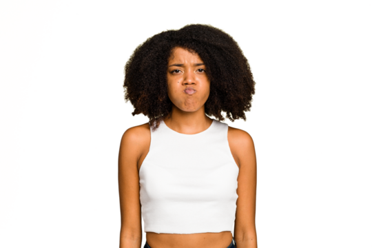 Young African American woman isolated blows cheeks, has tired expression. Facial expression concept.