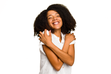 Young African American woman isolated hugs, smiling carefree and happy.