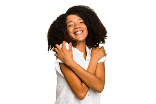 Young African American woman isolated hugs, smiling carefree and happy.