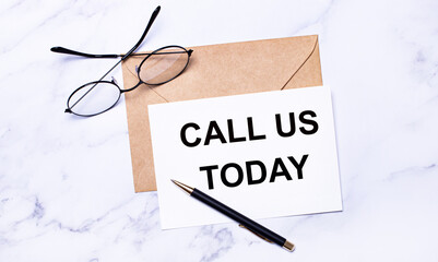 On the desktop there are reports, a burgundy notebook, a fountain pen and a white blank card with...